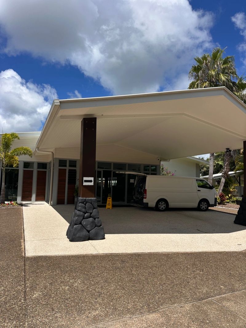 Exterior view of Aussie Carpet Cleaning business location in Banya with a white van parked outside and bright blue skies.